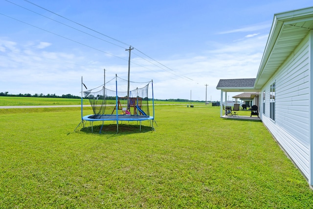 506 Addie Ln, Centralia, MO 65240 - view of green lawn with a trampoline