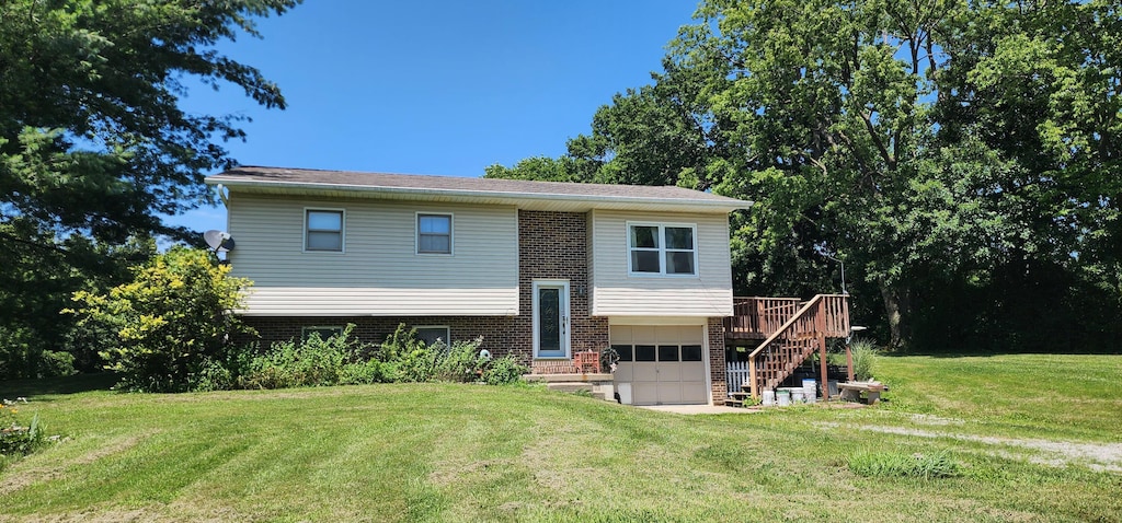 6501 W O B Brown Rd, Columbia, MO 65202 - rear view of property with brick siding, a garage, stairway, a yard, and a wooden deck