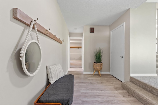 133 Manview Ln, Holts Summit, MO 65043 - foyer featuring light wood-style floors, a textured ceiling, and stairway