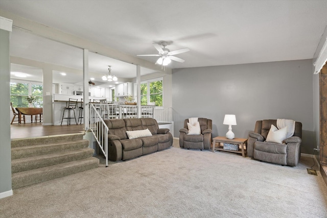 133 Manview Ln, Holts Summit, MO 65043 - carpeted living room featuring ceiling fan, a chandelier, and stairway