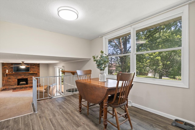 133 Manview Ln, Holts Summit, MO 65043 - dining room with wood finished floors and a brick fireplace