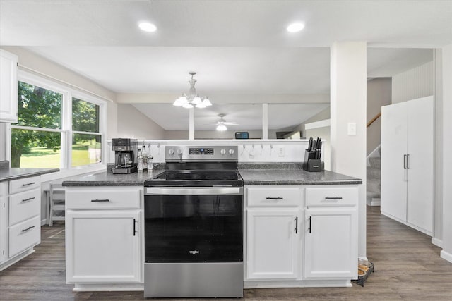133 Manview Ln, Holts Summit, MO 65043 - kitchen featuring stainless steel electric stove, white cabinets, wood finished floors, recessed lighting, and vaulted ceiling