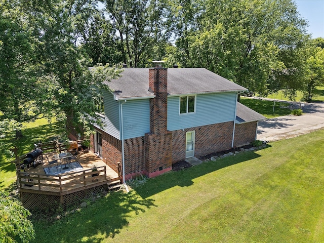 133 Manview Ln, Holts Summit, MO 65043 - view of home's exterior featuring brick siding, a chimney, a yard, a deck, and roof with shingles