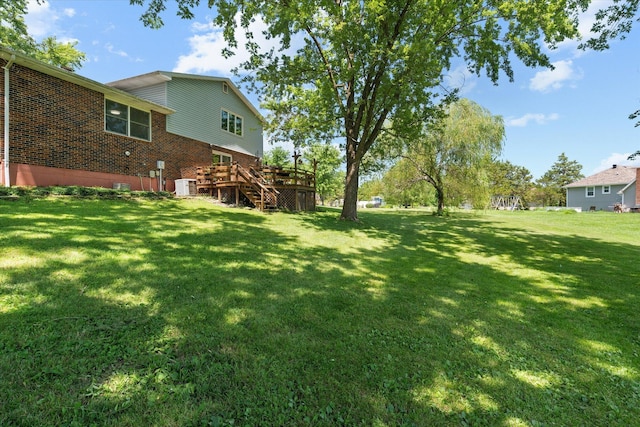 133 Manview Ln, Holts Summit, MO 65043 - view of grassy yard featuring stairs and a deck