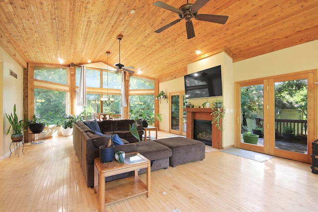 4241 E Ketterer Rd, Columbia, MO 65202 - living area with wood ceiling, a ceiling fan, a glass covered fireplace, wood-type flooring, and plenty of natural light