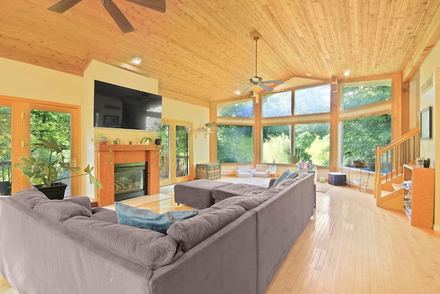 4241 E Ketterer Rd, Columbia, MO 65202 - living room with a ceiling fan, wood ceiling, a fireplace with flush hearth, hardwood / wood-style flooring, and lofted ceiling