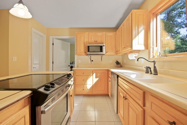 4241 E Ketterer Rd, Columbia, MO 65202 - kitchen with appliances with stainless steel finishes, light brown cabinets, light countertops, and light tile patterned floors