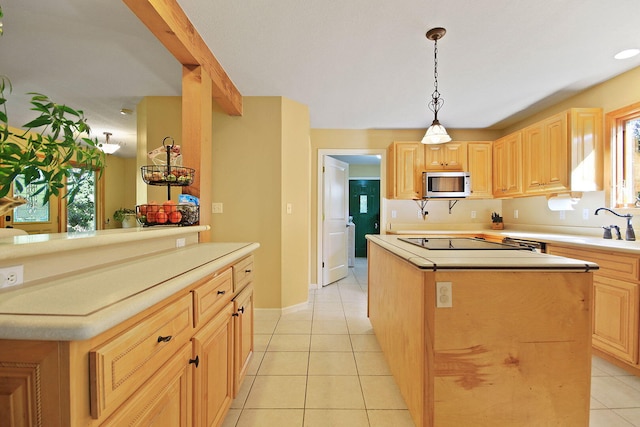 4241 E Ketterer Rd, Columbia, MO 65202 - kitchen featuring a center island, light tile patterned flooring, light brown cabinets, and plenty of natural light