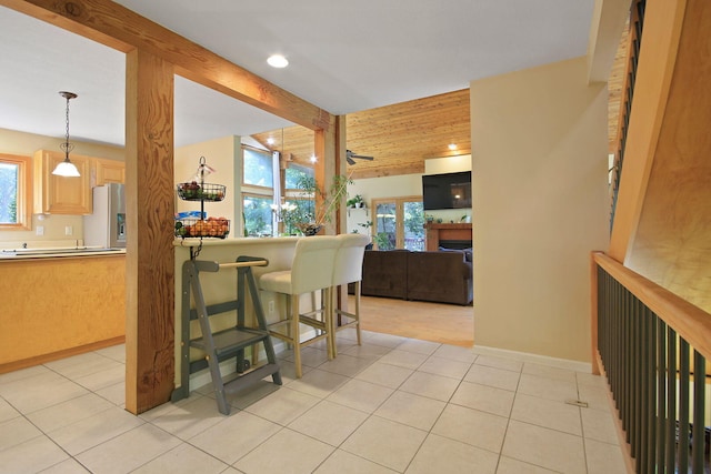 4241 E Ketterer Rd, Columbia, MO 65202 - kitchen with healthy amount of natural light, stainless steel fridge with ice dispenser, light tile patterned floors, recessed lighting, and beam ceiling
