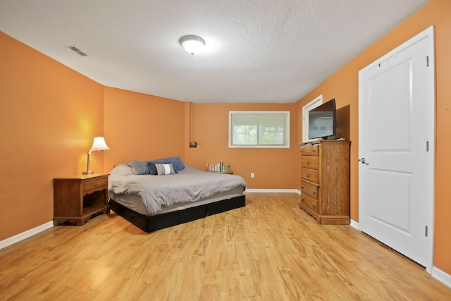 4241 E Ketterer Rd, Columbia, MO 65202 - bedroom with a textured ceiling and light wood finished floors