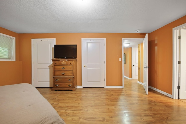 4241 E Ketterer Rd, Columbia, MO 65202 - bedroom featuring light wood finished floors and a textured ceiling