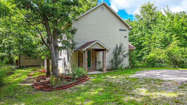 4241 E Ketterer Rd, Columbia, MO 65202 - view of front facade with stone siding and a front lawn