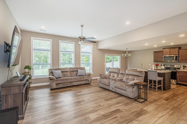 2905 N N Garth Ave, Columbia, MO 65202 - living room featuring light wood finished floors, a chandelier, a ceiling fan, and recessed lighting