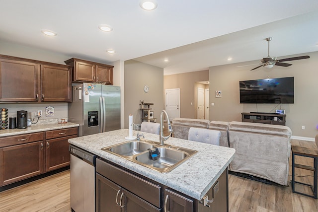 2905 N N Garth Ave, Columbia, MO 65202 - kitchen featuring appliances with stainless steel finishes, ceiling fan, light countertops, a kitchen island with sink, and light wood-type flooring