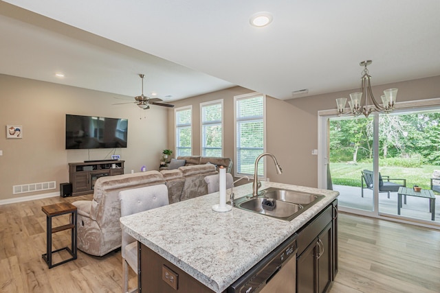 2905 N N Garth Ave, Columbia, MO 65202 - kitchen with stainless steel dishwasher, light wood-type flooring, hanging light fixtures, a ceiling fan, and an island with sink