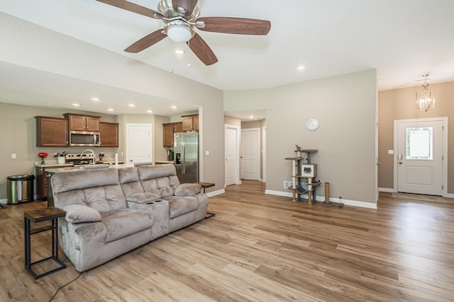 2905 N N Garth Ave, Columbia, MO 65202 - living room featuring light wood-style floors, recessed lighting, ceiling fan, and a chandelier