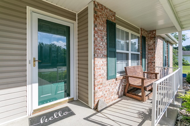 1703 Osage Dr, Columbia, MO 65202 - view of exterior entry featuring a porch and brick siding