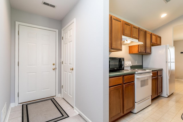 1703 Osage Dr, Columbia, MO 65202 - kitchen featuring white electric range, under cabinet range hood, black microwave, brown cabinetry, and light tile patterned floors