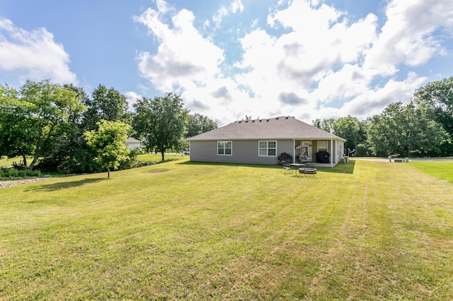 1703 Osage Dr, Columbia, MO 65202 - back of house featuring a yard and a fire pit