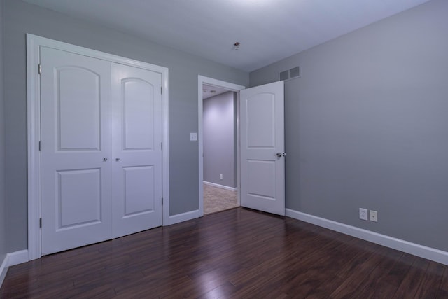 7700 N Ballew Rd, Hallsville, MO 65255 - unfurnished bedroom featuring dark wood-style floors and a closet