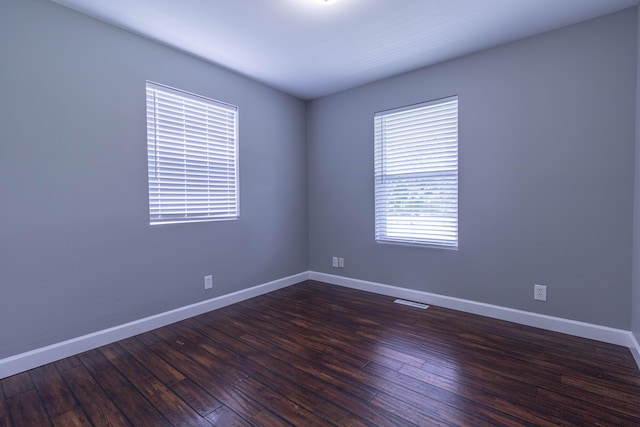 7700 N Ballew Rd, Hallsville, MO 65255 - empty room with dark wood-style floors and baseboards