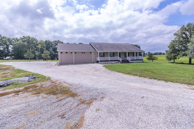 7700 N Ballew Rd, Hallsville, MO 65255 - ranch-style home featuring covered porch, driveway, a garage, and a front lawn