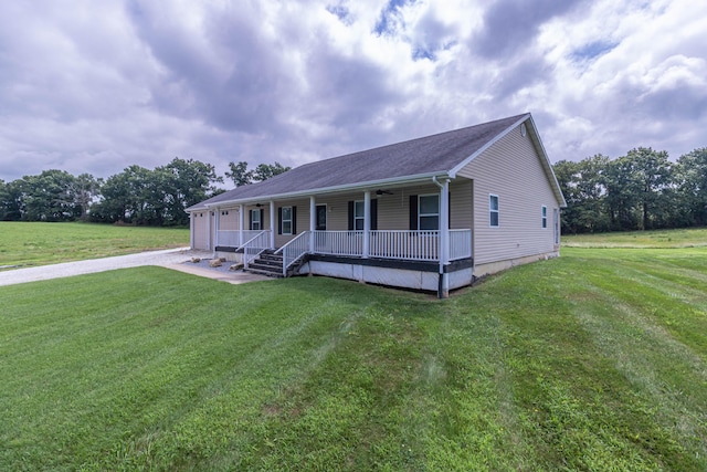 7700 N Ballew Rd, Hallsville, MO 65255 - view of front of house with a porch, a front lawn, a garage, and driveway