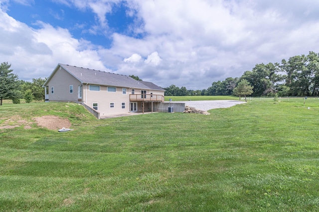 7700 N Ballew Rd, Hallsville, MO 65255 - rear view of house with a lawn and a wooden deck