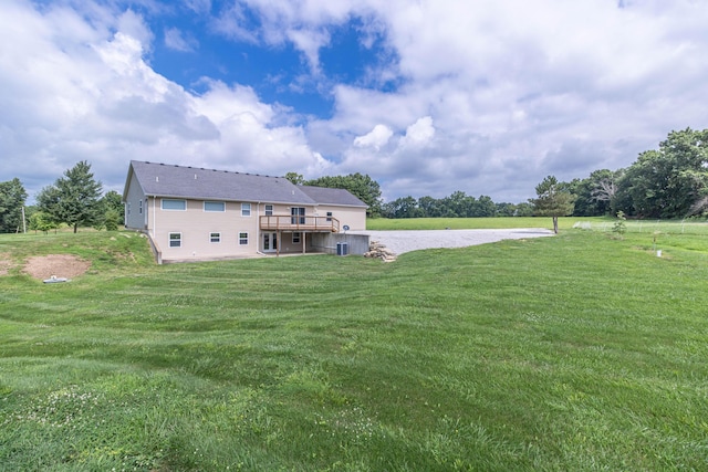 7700 N Ballew Rd, Hallsville, MO 65255 - rear view of house featuring a lawn and a deck