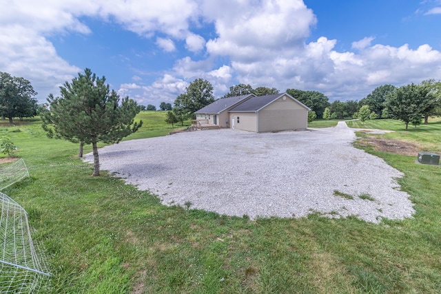7700 N Ballew Rd, Hallsville, MO 65255 - view of side of home featuring driveway and a yard