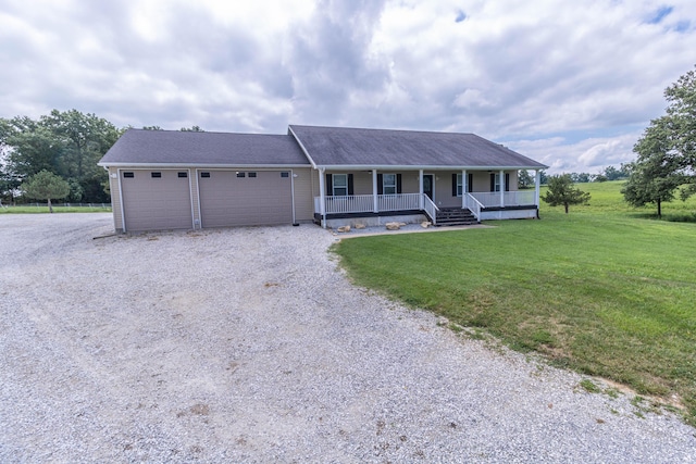 7700 N Ballew Rd, Hallsville, MO 65255 - view of front facade featuring a porch, gravel driveway, a front lawn, and a garage