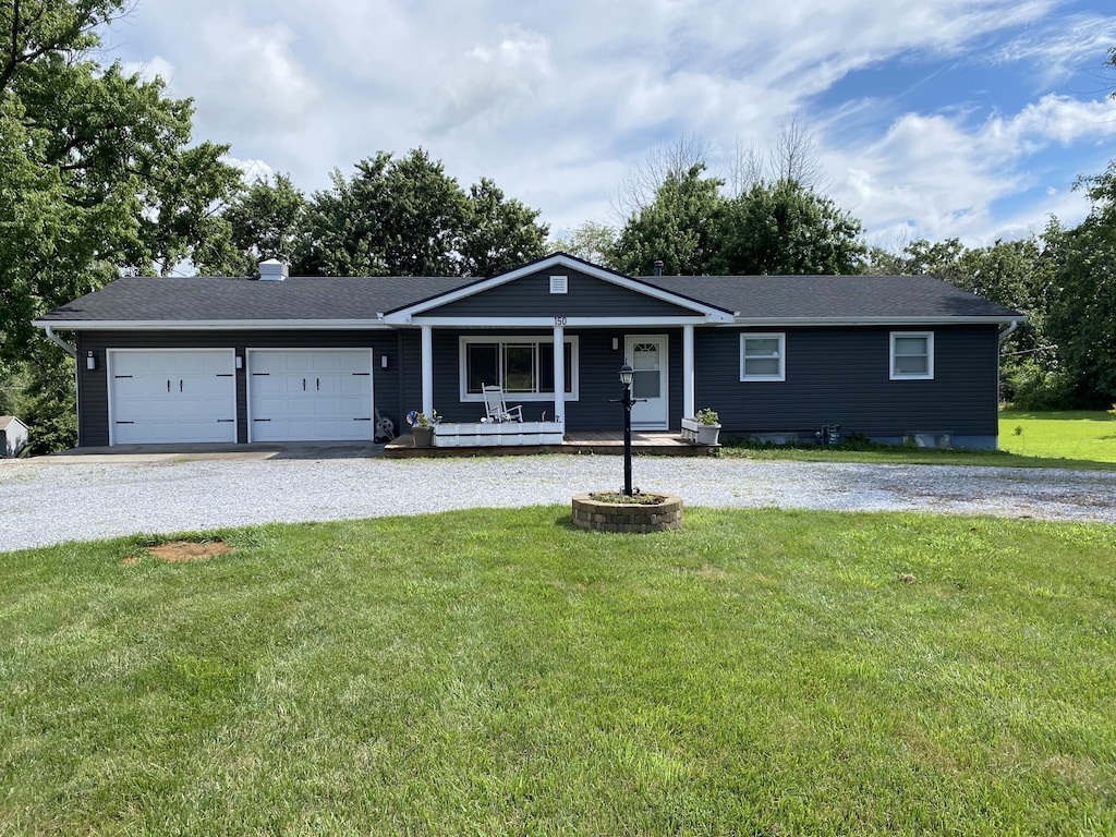 150 E Hinton Rd, Columbia, MO 65202 - ranch-style home featuring covered porch, driveway, a garage, a front yard, and roof with shingles