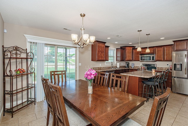 3405 Piranha Ct, Columbia, MO 65202 - dining area with a chandelier, light tile patterned floors, and recessed lighting