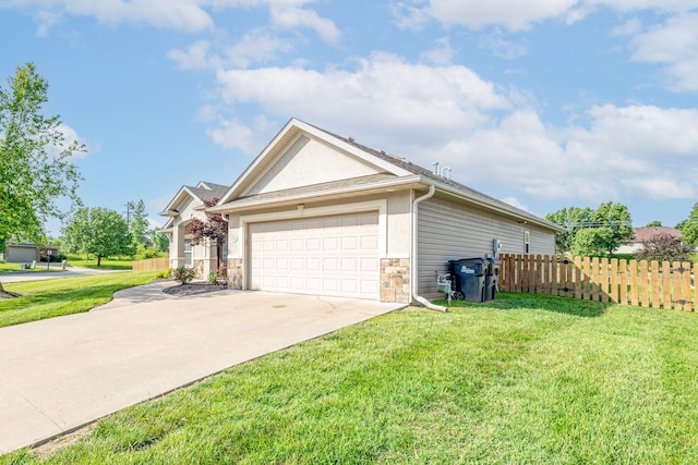 3405 Piranha Ct, Columbia, MO 65202 - view of side of home with concrete driveway, an attached garage, and stucco siding