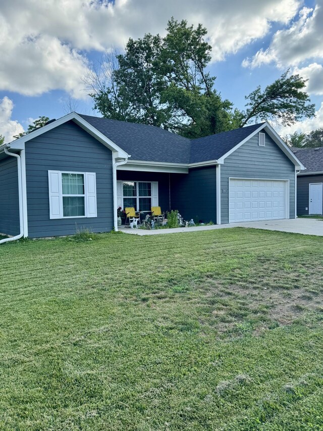 200 W Lakeview Ave, Centralia, MO 65240 - ranch-style home featuring a garage, a front lawn, concrete driveway, roof with shingles, and a porch