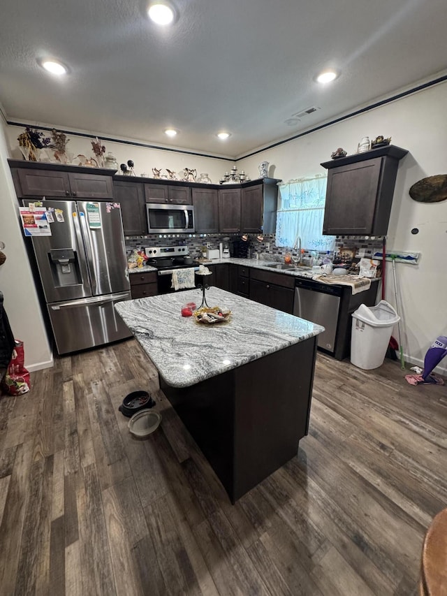 200 W Lakeview Ave, Centralia, MO 65240 - kitchen with appliances with stainless steel finishes, a center island, tasteful backsplash, dark brown cabinets, and dark wood-style floors
