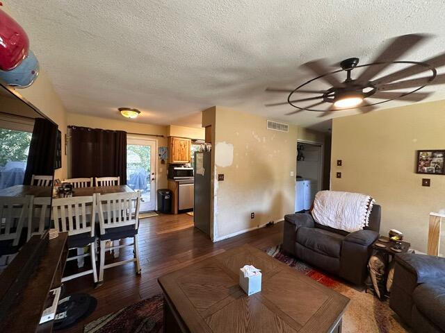 511 Turner Ave, Ashland, MO 65010 - living room with ceiling fan, a textured ceiling, and dark wood-style flooring