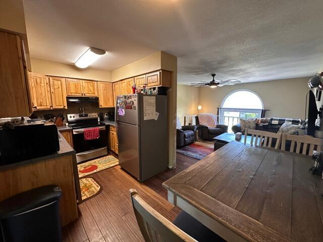 511 Turner Ave, Ashland, MO 65010 - kitchen with stainless steel appliances, dark wood-type flooring, open floor plan, a ceiling fan, and range hood
