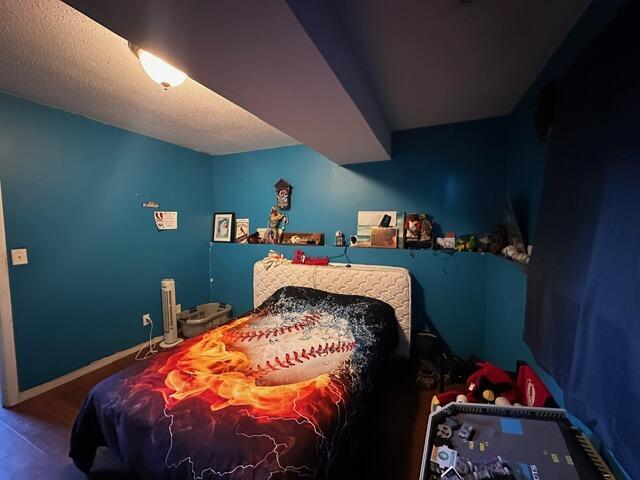 511 Turner Ave, Ashland, MO 65010 - bedroom with a textured ceiling and baseboards