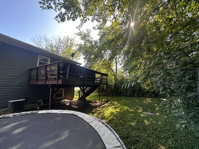 511 Turner Ave, Ashland, MO 65010 - view of grassy yard with stairway, a wooden deck, and a patio area