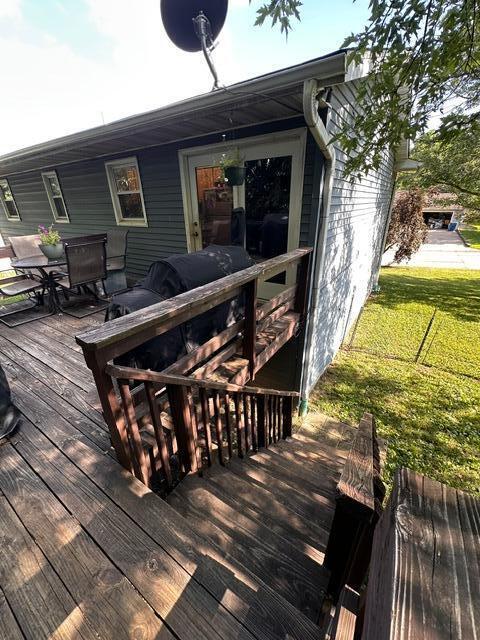 511 Turner Ave, Ashland, MO 65010 - wooden deck featuring outdoor dining space and a lawn