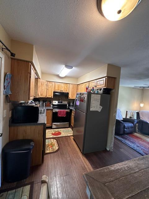 511 Turner Ave, Ashland, MO 65010 - kitchen featuring stainless steel range with electric cooktop, freestanding refrigerator, open floor plan, dark wood-style floors, and dark countertops