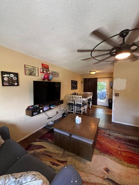 511 Turner Ave, Ashland, MO 65010 - living area featuring a ceiling fan, a textured ceiling, and wood finished floors