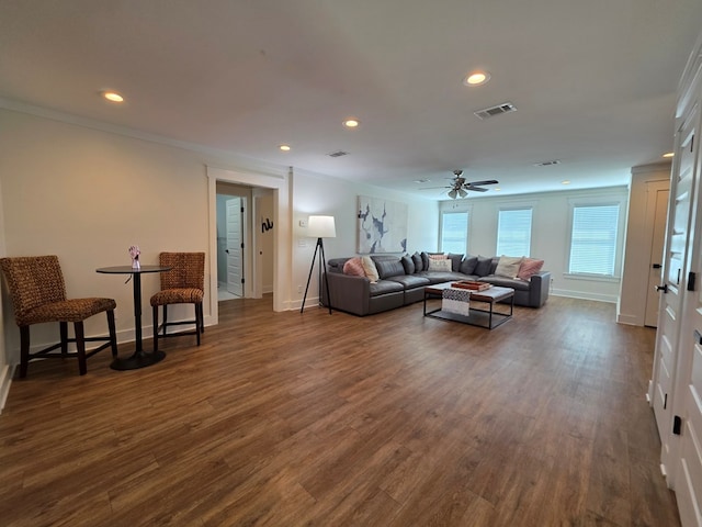 living room featuring crown molding, ceiling fan, dark wood finished floors, visible vents, and recessed lighting