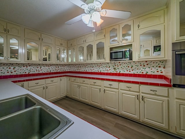 kitchen featuring backsplash, a sink, ceiling fan, and appliances with stainless steel finishes