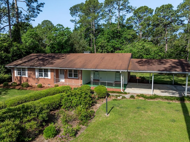 ranch-style house featuring a front yard, a shingled roof, an attached carport, covered porch, and brick siding