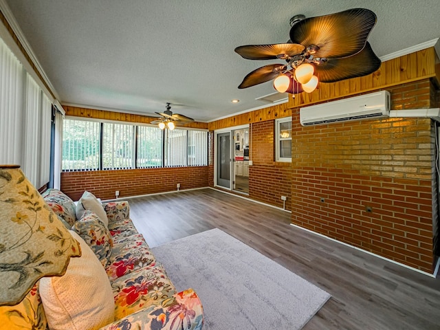 sunroom with ceiling fan and a wall unit AC