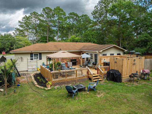 2222 Davis Ave, Tifton, GA 31794 - back of house with a gazebo, a wooden deck, and a fire pit