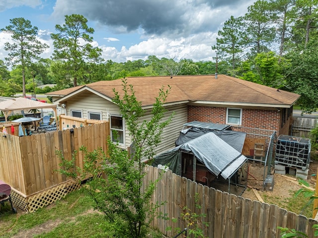 2222 Davis Ave, Tifton, GA 31794 - back of property with brick siding, a fenced backyard, and roof with shingles