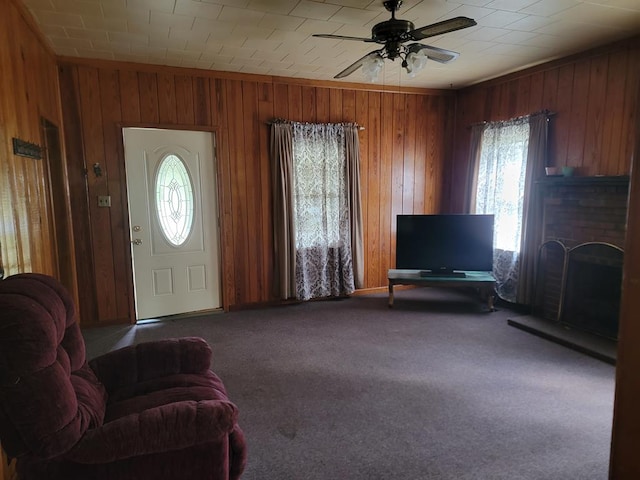 195 N Mattie Ave, Sycamore, GA 31790 - carpeted entryway with crown molding, wood walls, ceiling fan, and a fireplace